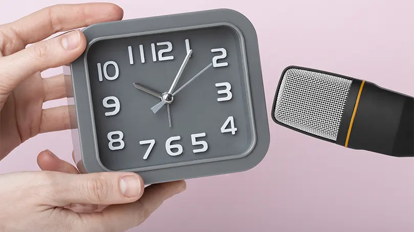 An image of a clock ticking close to a microphone for asmr.