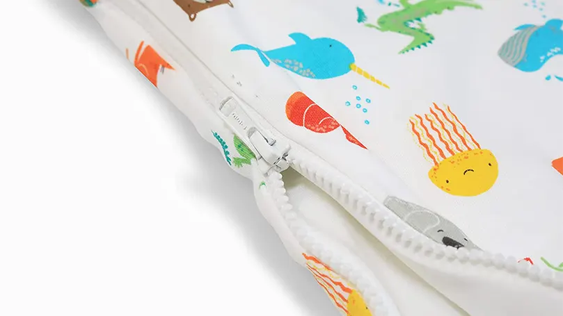An image of a close up of baby sleep bag's zipper.