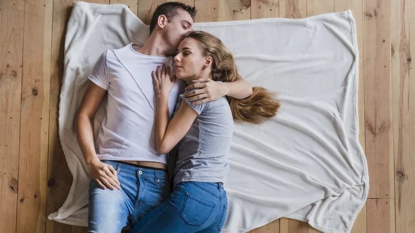 An image of a couple on the floor.