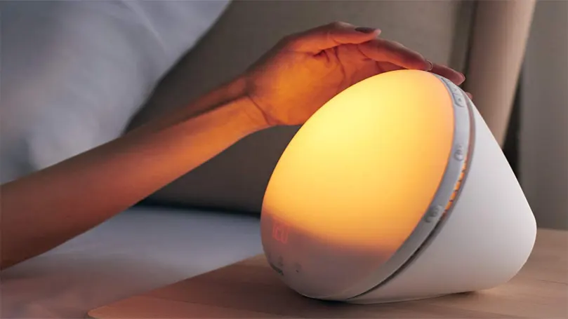 An image of a hand reaching for Philips night light.
