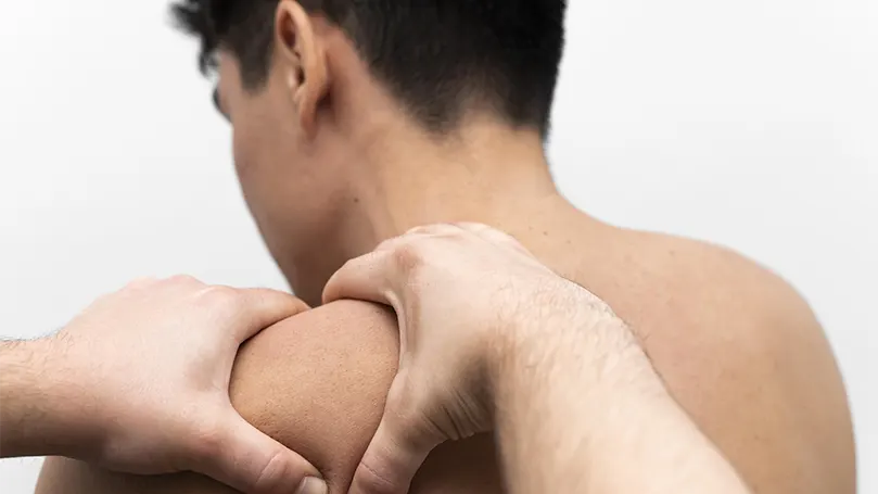 An image of a man with a frozen shoulder getting a massage