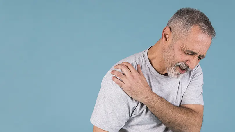 An image of a senior suffering from shoulder pain.