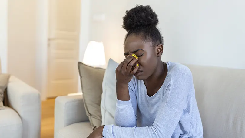 An image of a young black women having an eye fatigue,