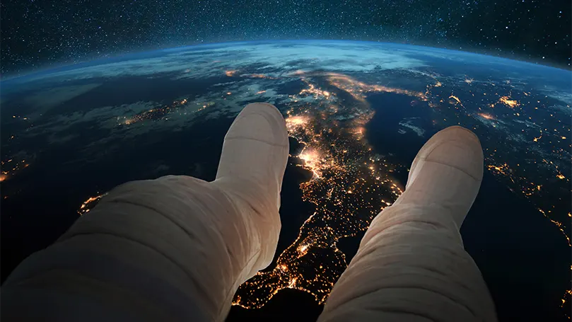 An image of an astronaut above the Earth.