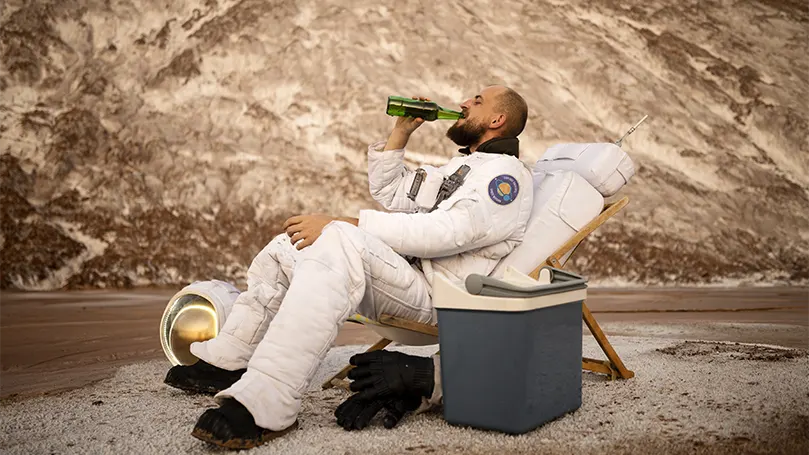An image of an astronaut drinking beer.