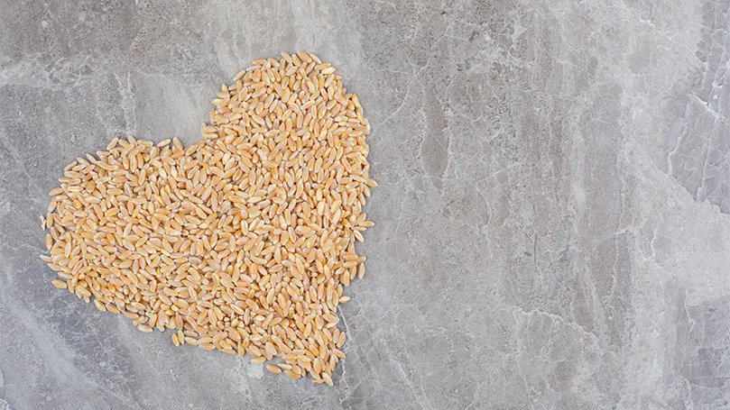 An image of whole grains in shape of heart.