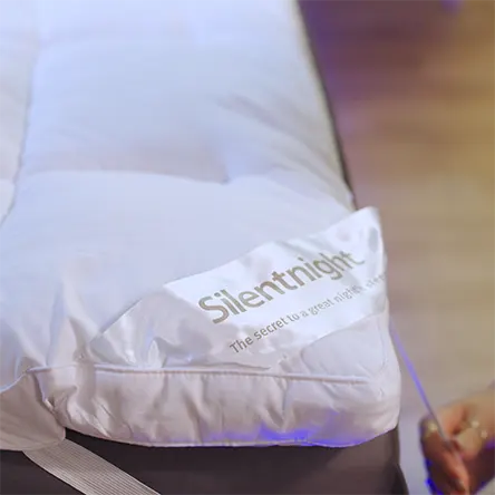 product image of Silentnight Ultimate Deep Sleep Mattress Topper while being put on a mattress by our reviewer