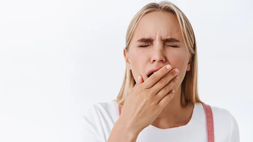 An image of a woman yawning.