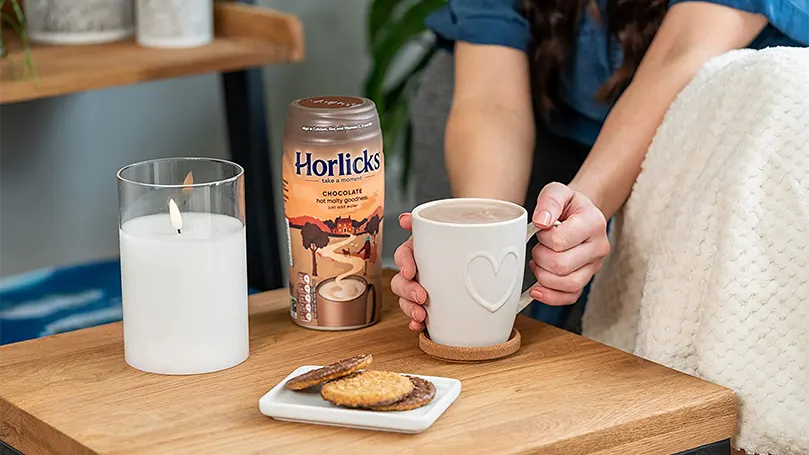 Horlicks and milk on table.