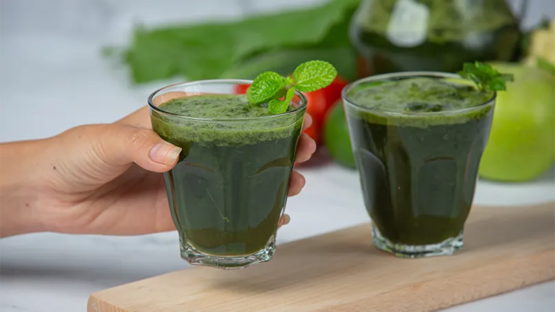 An image of two glasses of a spinach smoothie