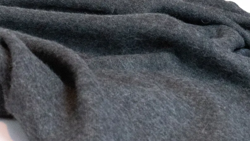 a close up photo of black Scooms Alpaca wool blanket