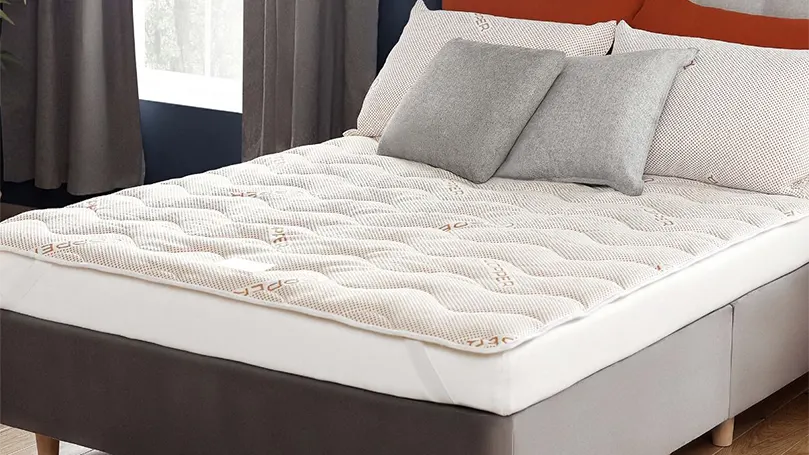 An image of Silentnight Wellbeing Copper mattress topper in bedroom.