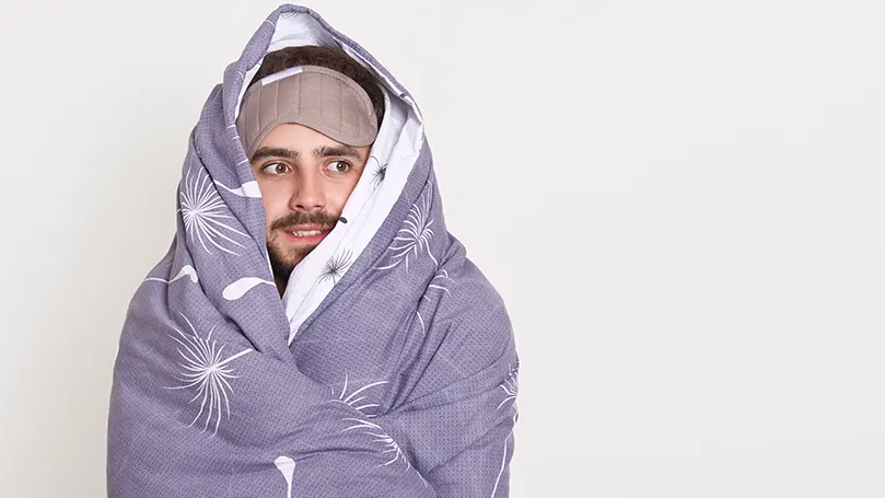 An image of a bearded guy wrapped in a blanket.