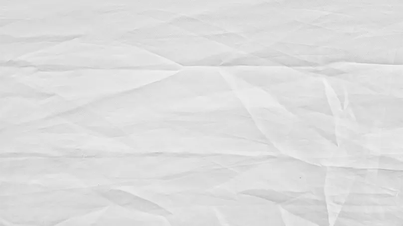 An image of a white sheet with wrinkles.