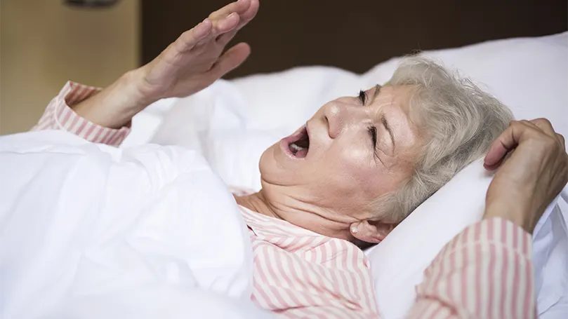 An image of an elder woman breathing through the nose.