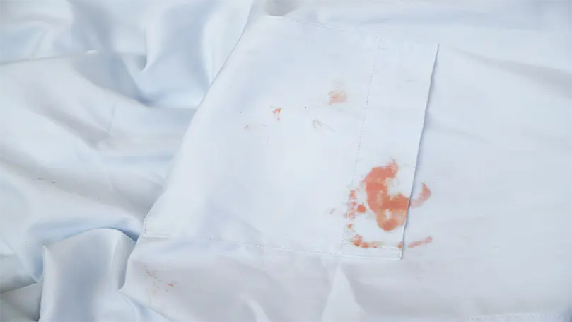 a blood stain on white sheets.