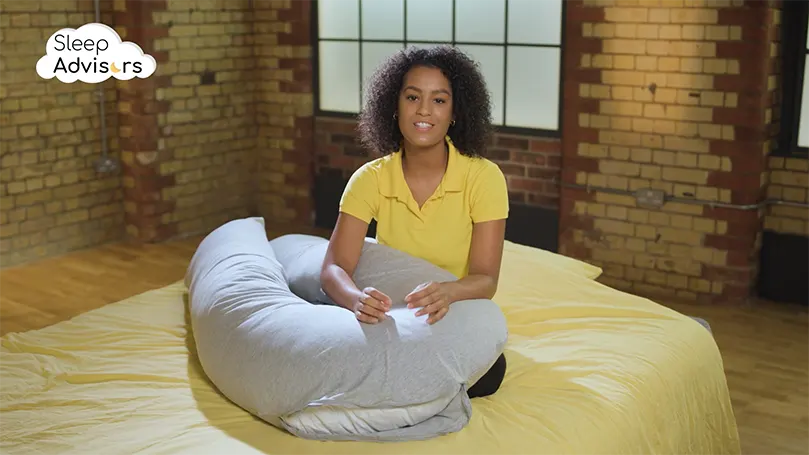 An image of a The Sleep Advisors reviewer during the Kally U-Shaped Pillow testing