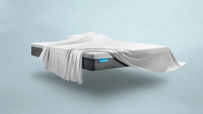 An image of simbatex foam mattress covered with sheets.