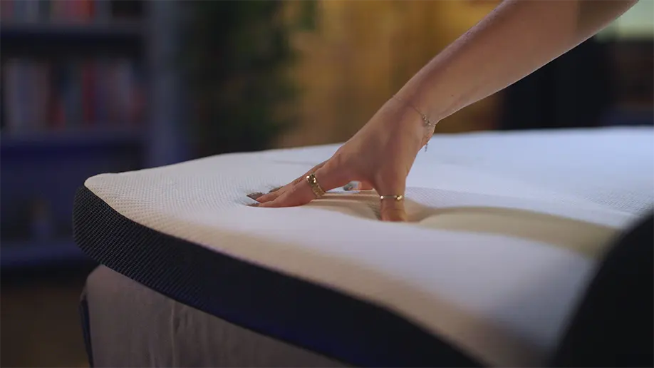 Our reviewer, Connie testing the Silentnight Wellbeing Cool Touch Mattress Topper firmness