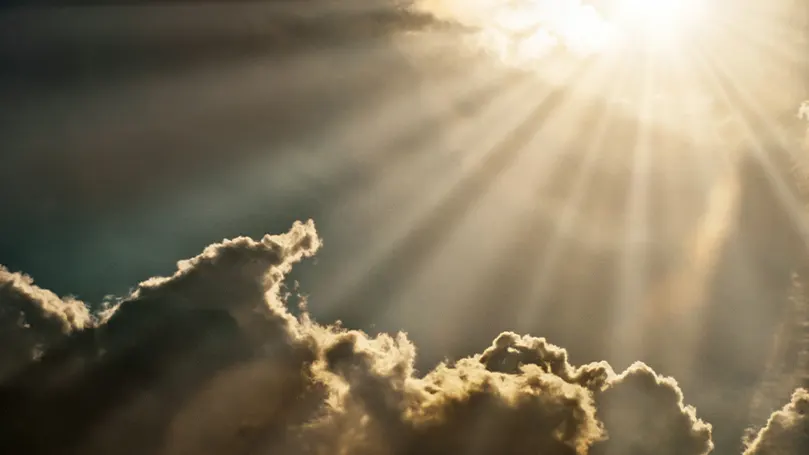 An image of sunlight shinning on some clouds