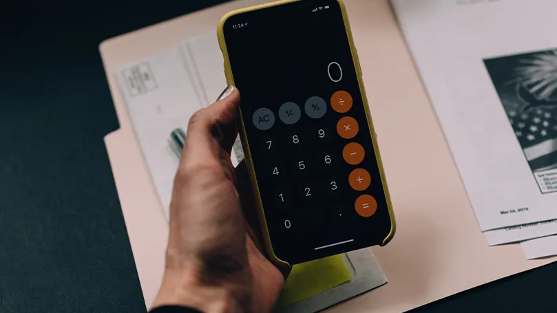 An image of a person holding a calculator