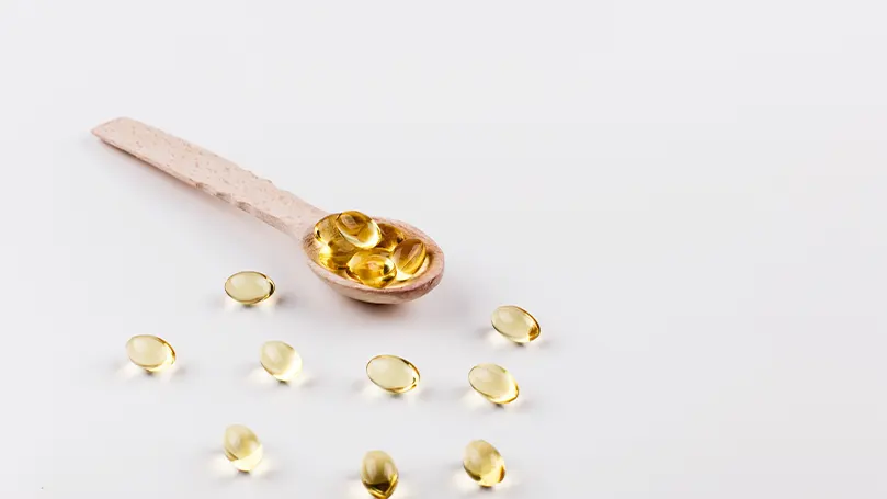 An image of a spoon fulled with vitamin D supplements