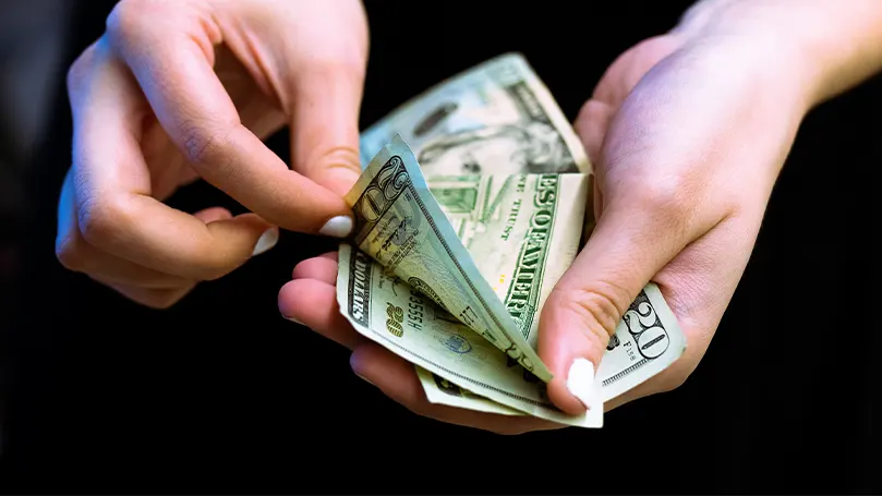 An image of a person counting their money