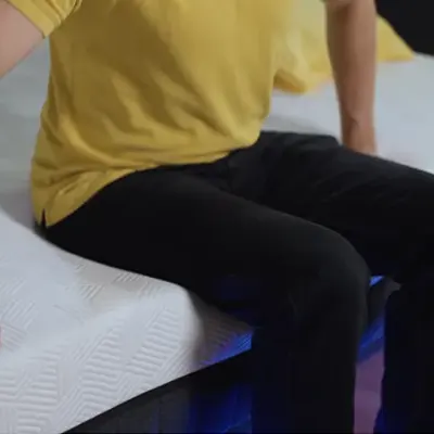 Someone sitting on Panda Hybrid Bamboo Mattress Pro.