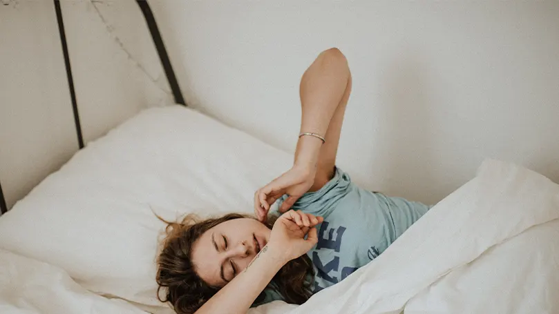 An image of a woman sleeping in bed