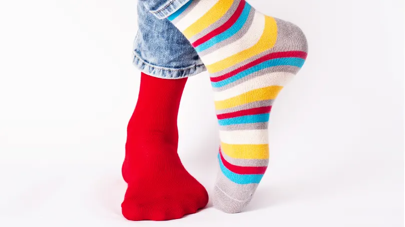 An image of a person wearing two different types of socks