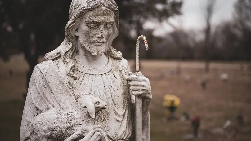 An image of a pastor statue and religious figure