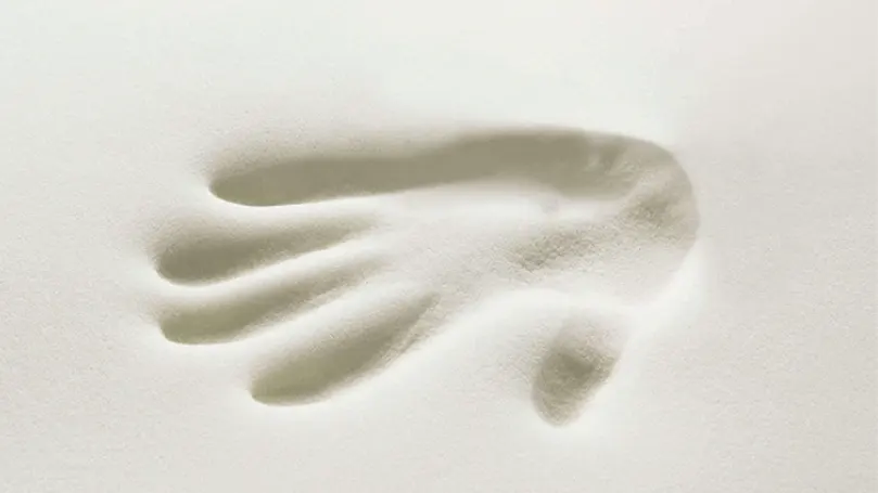 An image of a hand imprint in memory foam