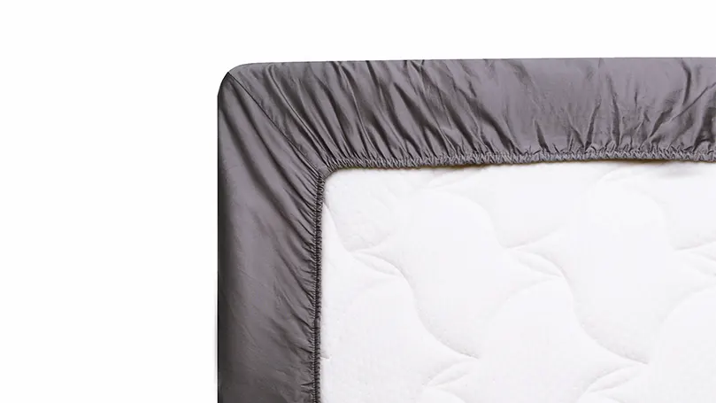 An image of a mattress inside of a perfectly fitted sheet