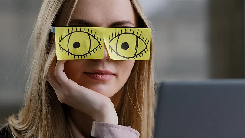 An image of a woman trying to stay awake with drawn on eyes