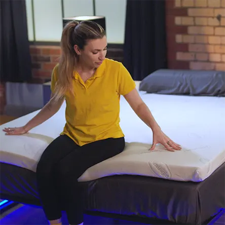 our reviewer sitting on the Silentnight Impress Memory Foam Mattress Topper