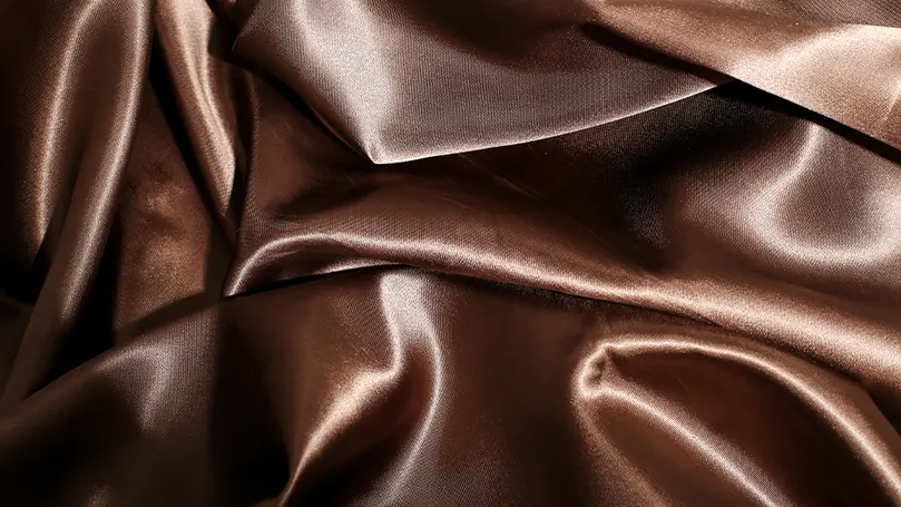 a close up of brown satin sheets