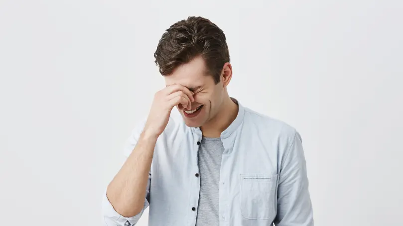 An image of a man laughing.