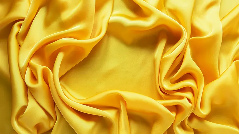 a close up of yellow satin.