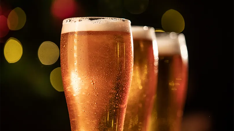 An image of three glasses of beer placed in a row