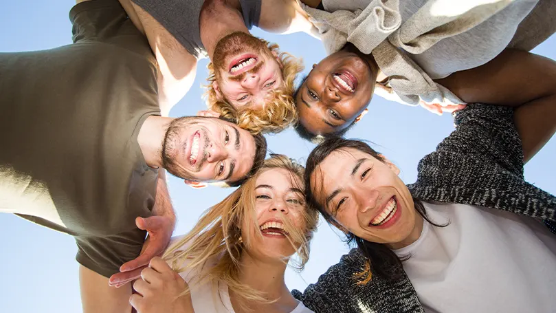 An image of friends taking a photo and laughing.