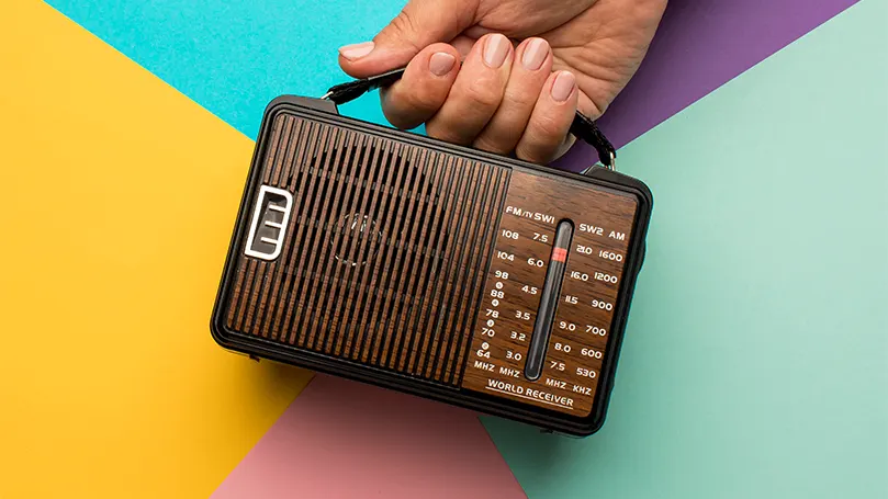 An image of a person holding a radio.