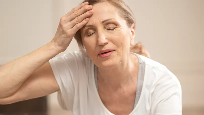 A woman suffering from hot flashes