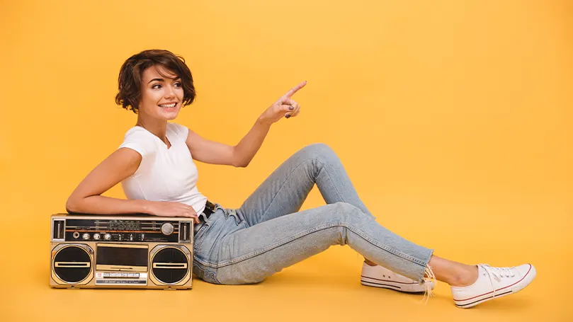 An image of a person leaning on a radio.