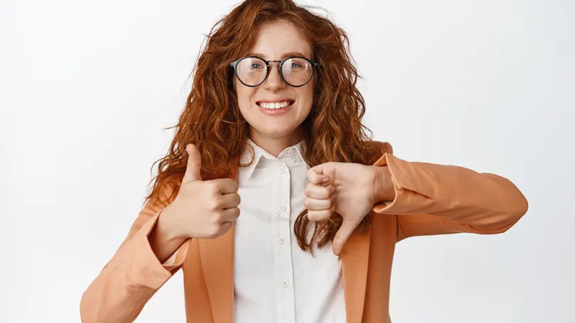 Woman with glasses showing thumbs up and thumbs down