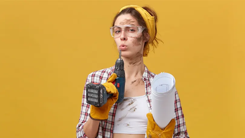 An image of a woman with tools catching her breath after a DIY project