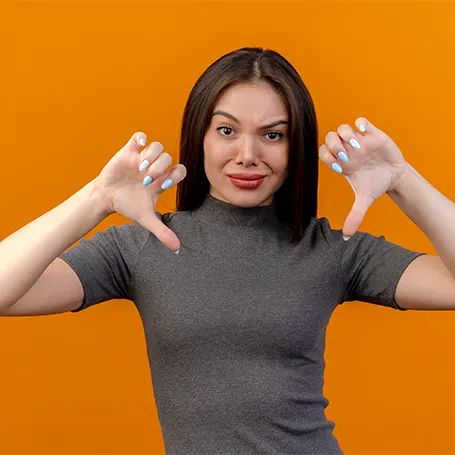 An image of a woman holding two thumbs down