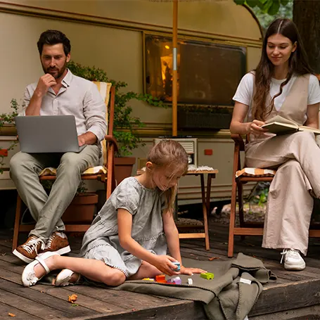 An image of a family in front of their camping van