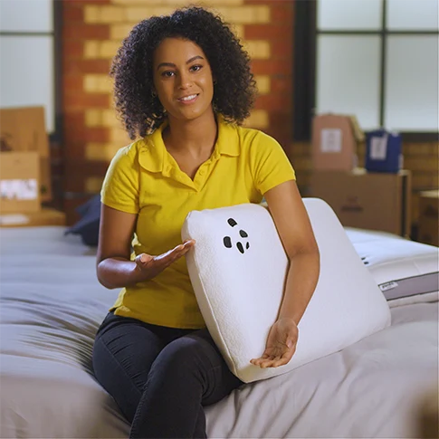 our reviewer holding the Panda memory foam pillow