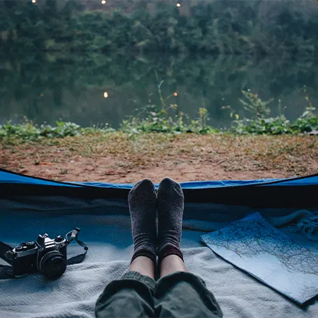 A woman sitting in the tent and looking outside