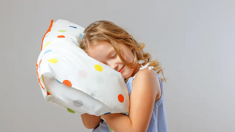 An image of a child hugging their pillow